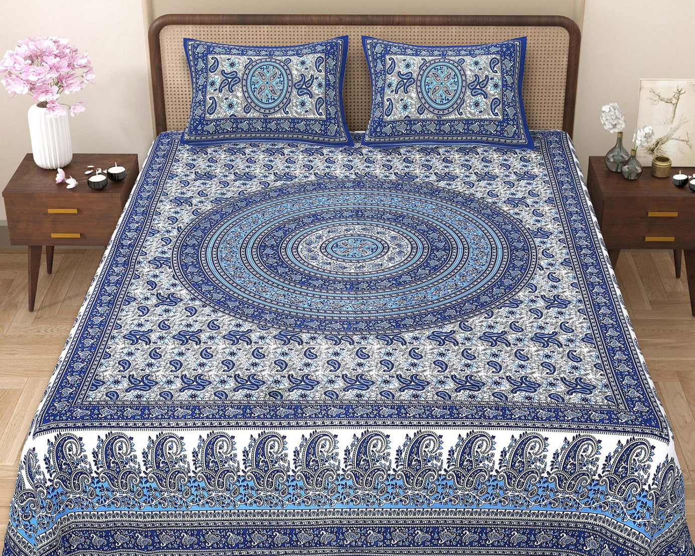 Blue and white patterned bedspread on a bed with matching pillows in a bedroom setting.