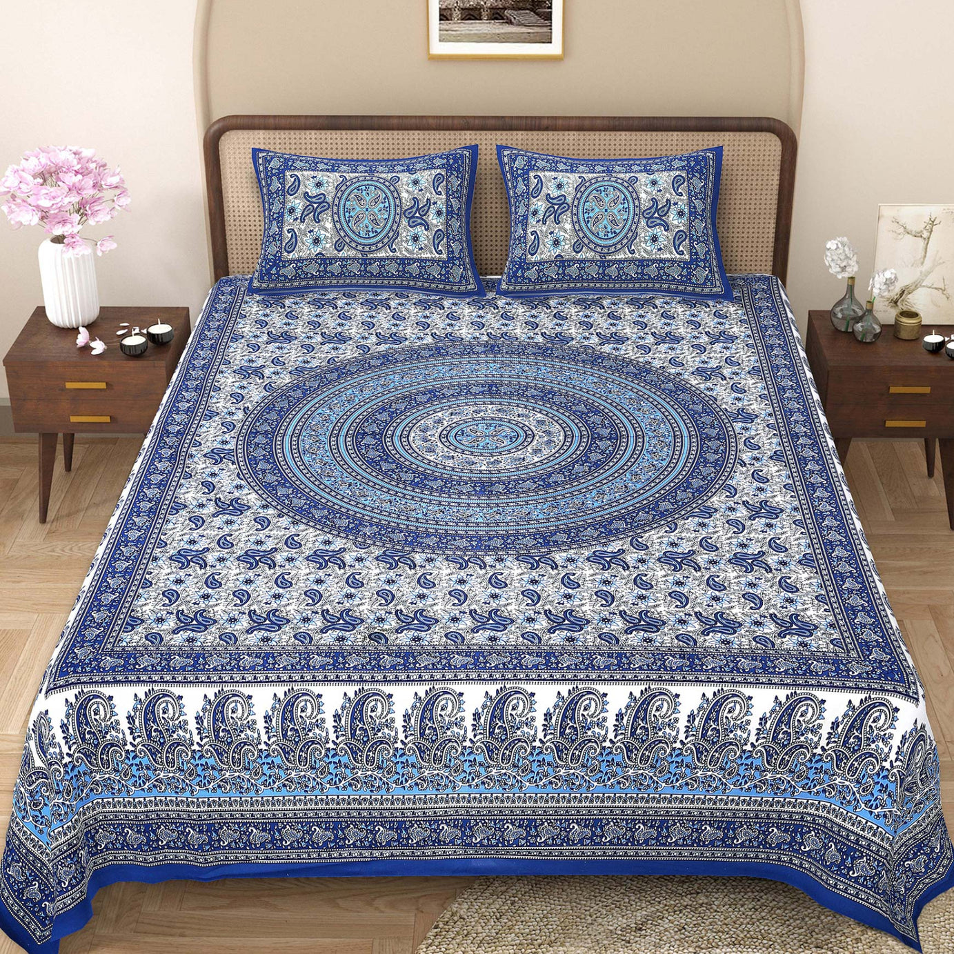 Blue and white patterned bedspread on a bed with matching pillows in a bedroom setting.