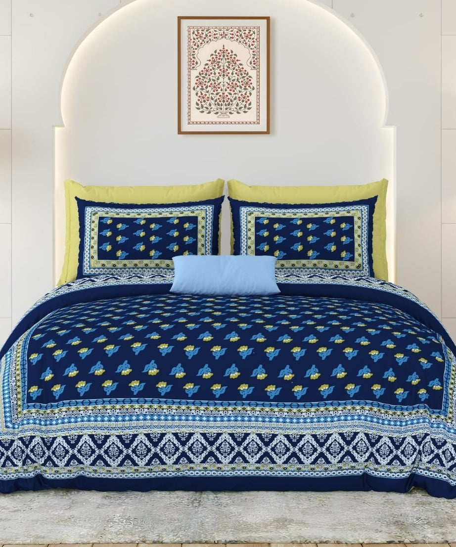 Blue and yellow patterned bedding set on a bed with a white headboard.