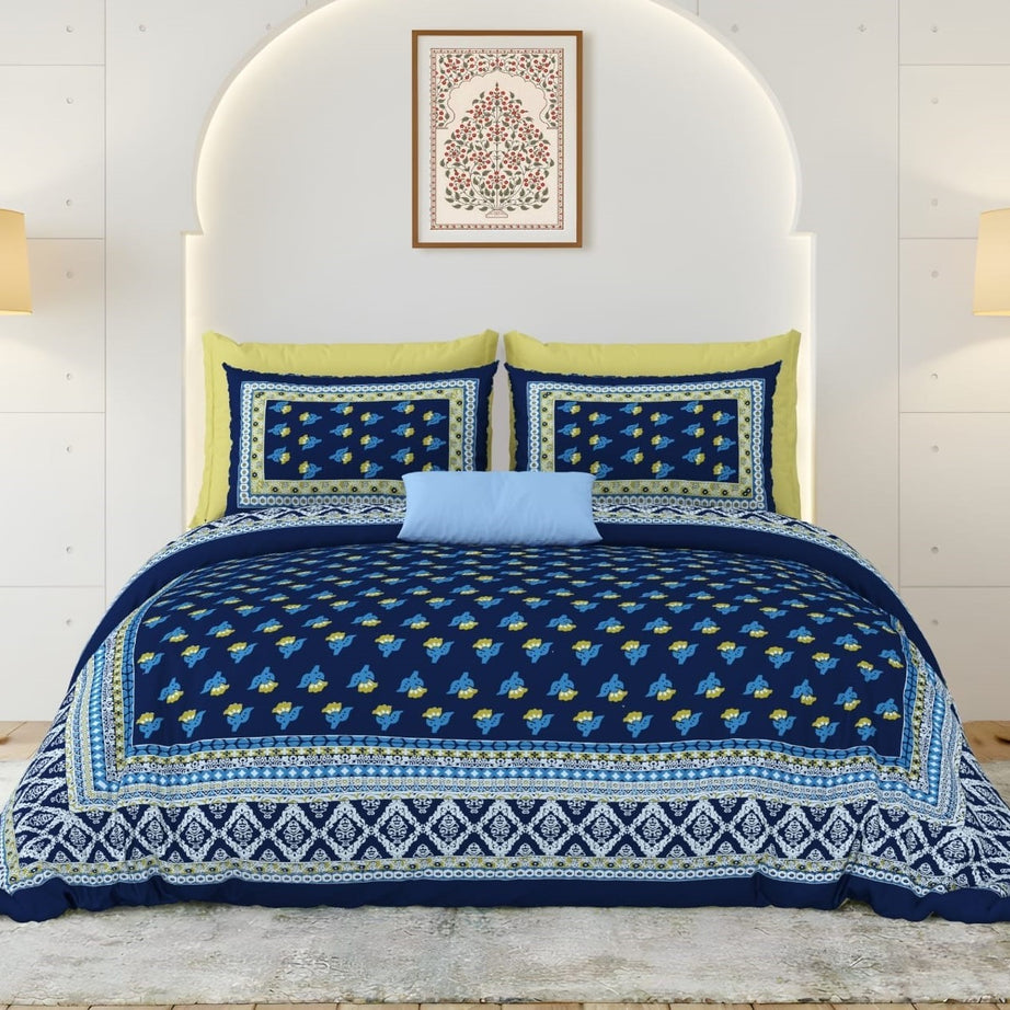Blue and yellow patterned bedding set on a bed with a white headboard.