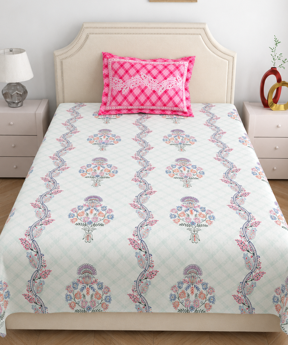 Bed with floral patterned bedspread and pink checkered pillow, nightstands on either side.